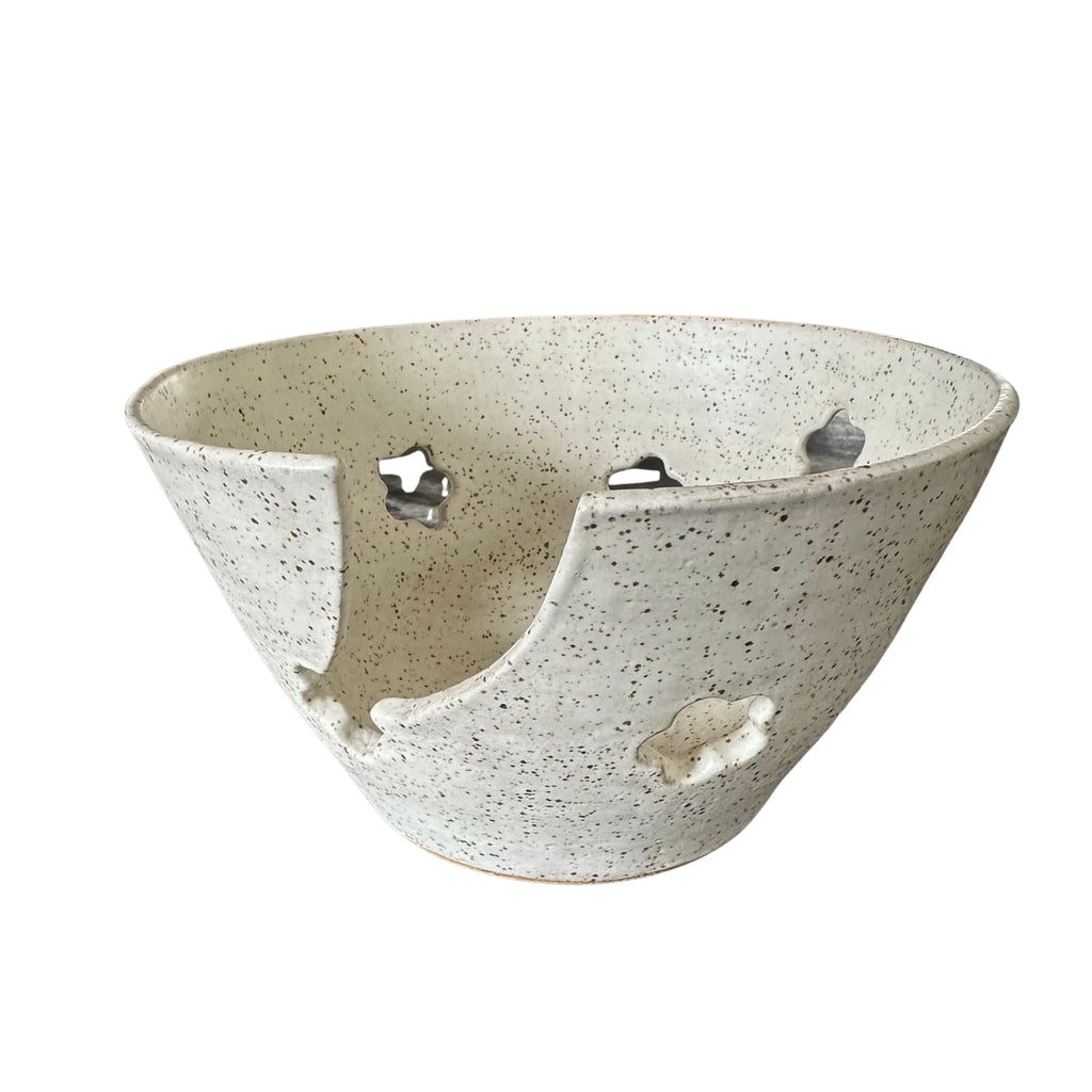 Speckled ceramic yarn bowl in contemporary shape with flower shaped cutouts