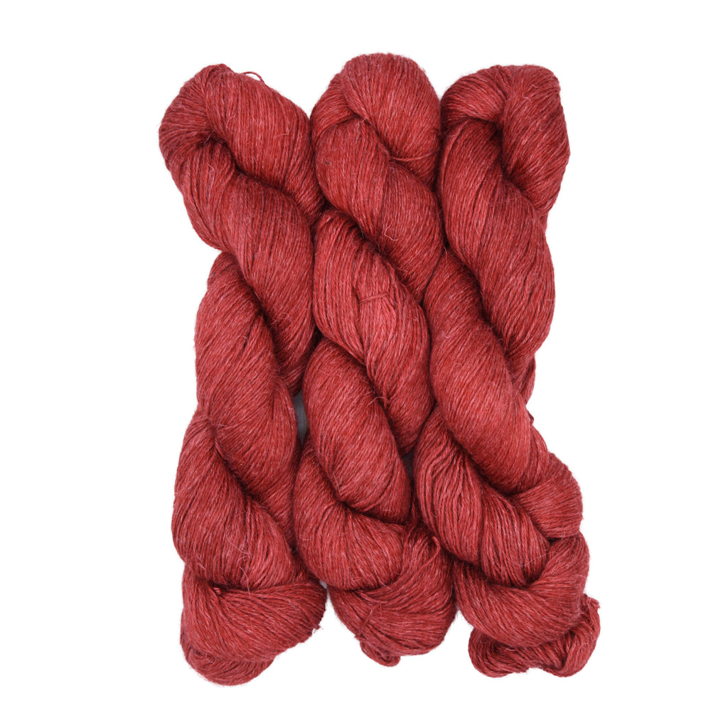 Three skeins of red yarn on a white background
