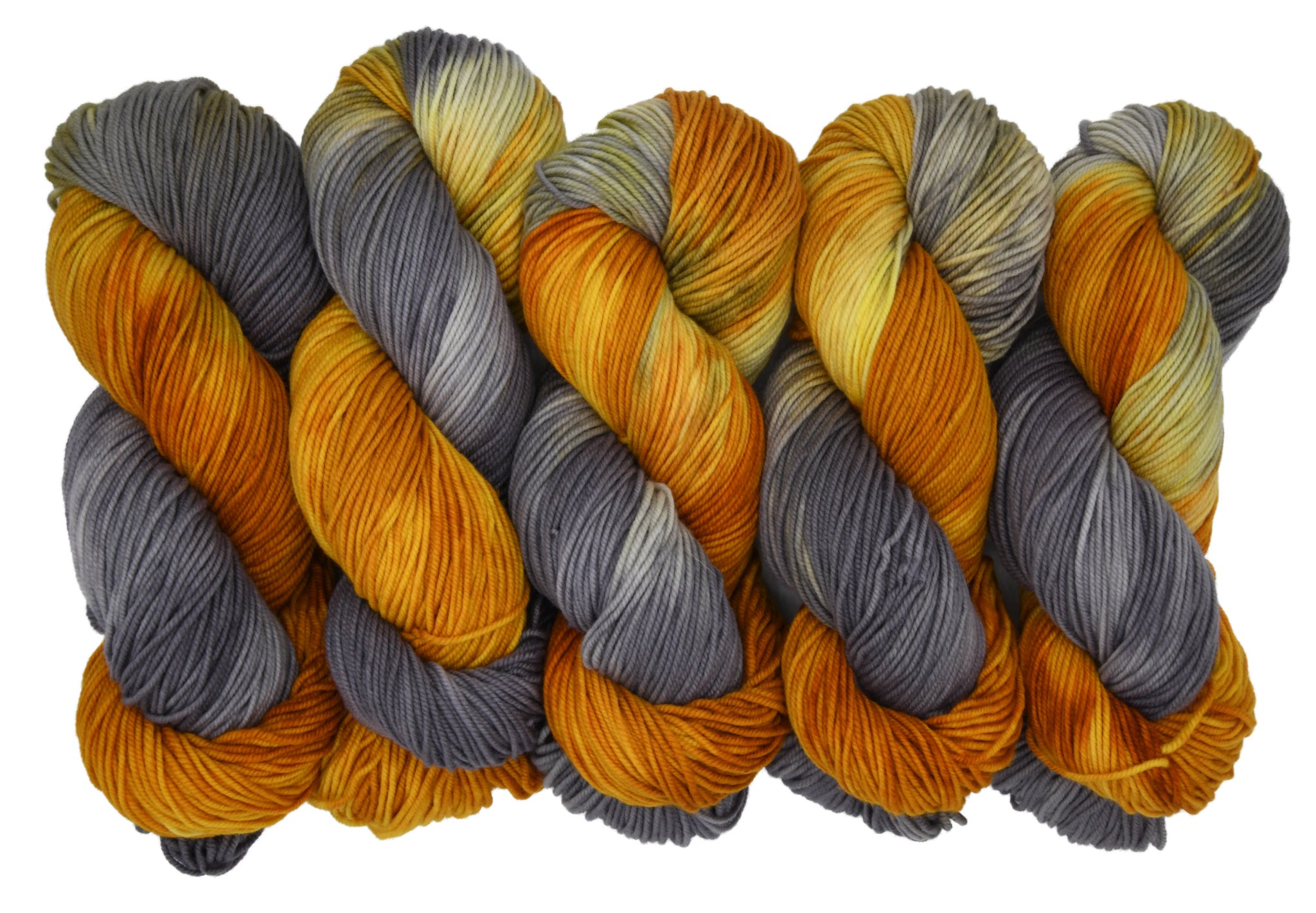 Five skeins of Woolly Headed Ideas DK weight hand-dyed yarn in colorway Driftwood & Dandelion on a white background