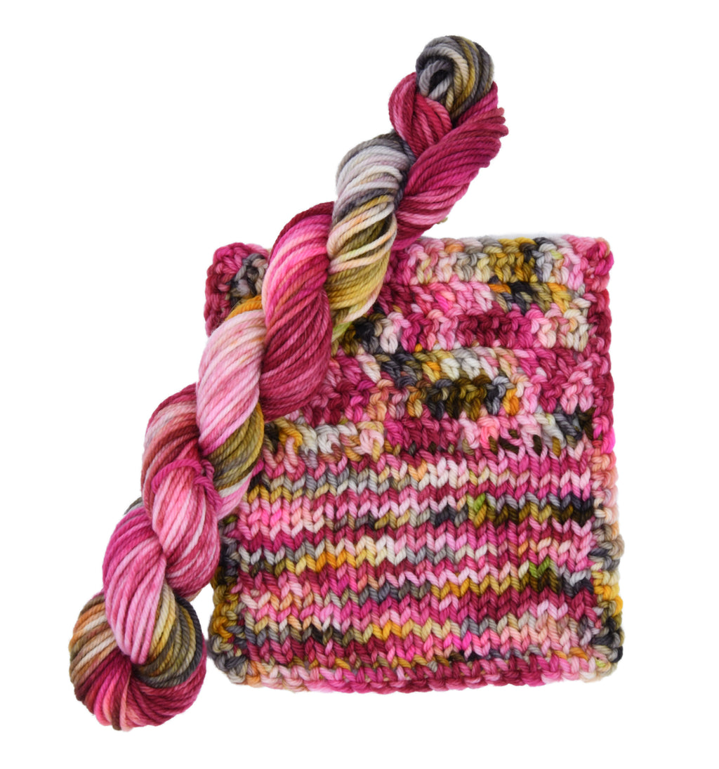 Gordon’s Garden Party hand-dyed yarn and sample, featuring yellow, red, deep green, maroon, and dark charcoal gray in a richly layered multicolor colorway by Woolly Headed Ideas