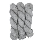 Three skeins of gray yarn twisted together on a white background