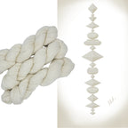 Hand dyed yarn skein in the Ivory Tower colorway featuring a soft ivory neutral tone.