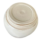 Bottom view of a round ceramic yarn bowl shown on a white background.