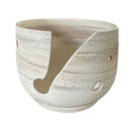 A handmade ceramic yarn bowl thrown using marbled clay shown on a plain white background.