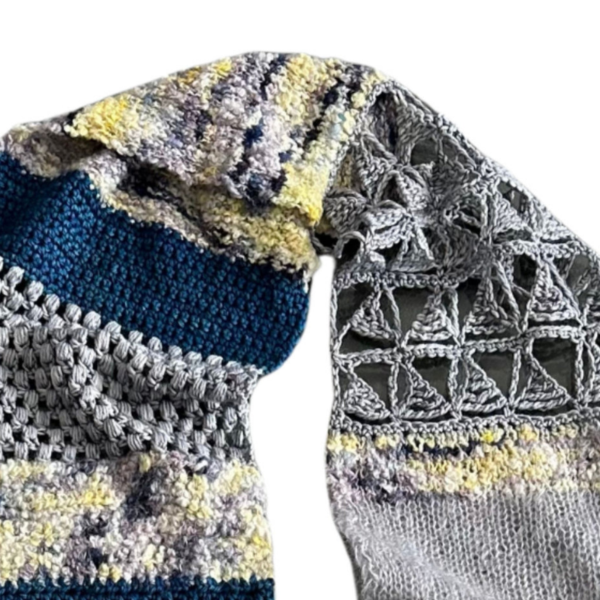 Close-up of knit and crocheted Sampler Scarf showing stitch texture on a white background