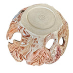 Bottom view of a ceramic yarn bowl featuring a textured, organic leaf exterior and large side cutouts, shown from a top-down view on a white background.
