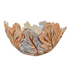 A decorative ceramic bowl with a leaf-like raised pattern, featuring a glossy finish in warm terracotta brown and light blue-gray tones, isolated on a white background.